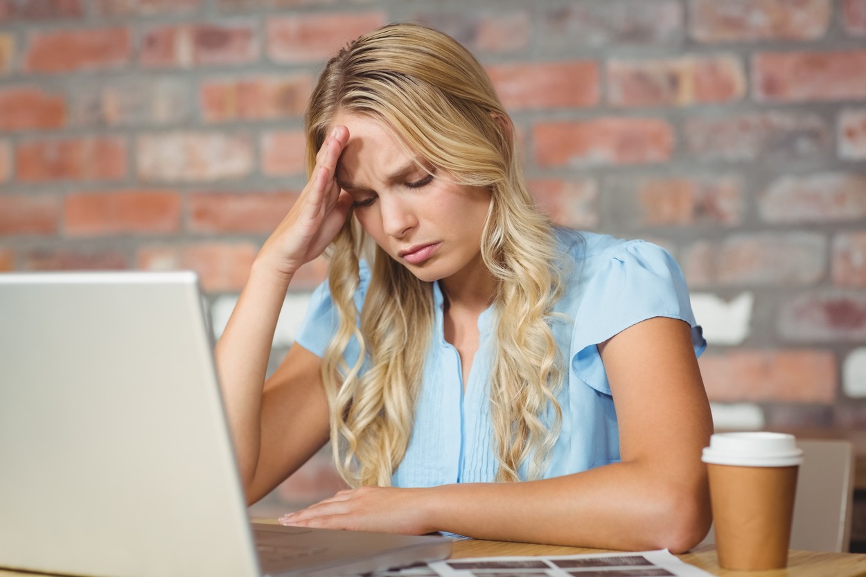 Stressed woman sitting in front of laptop